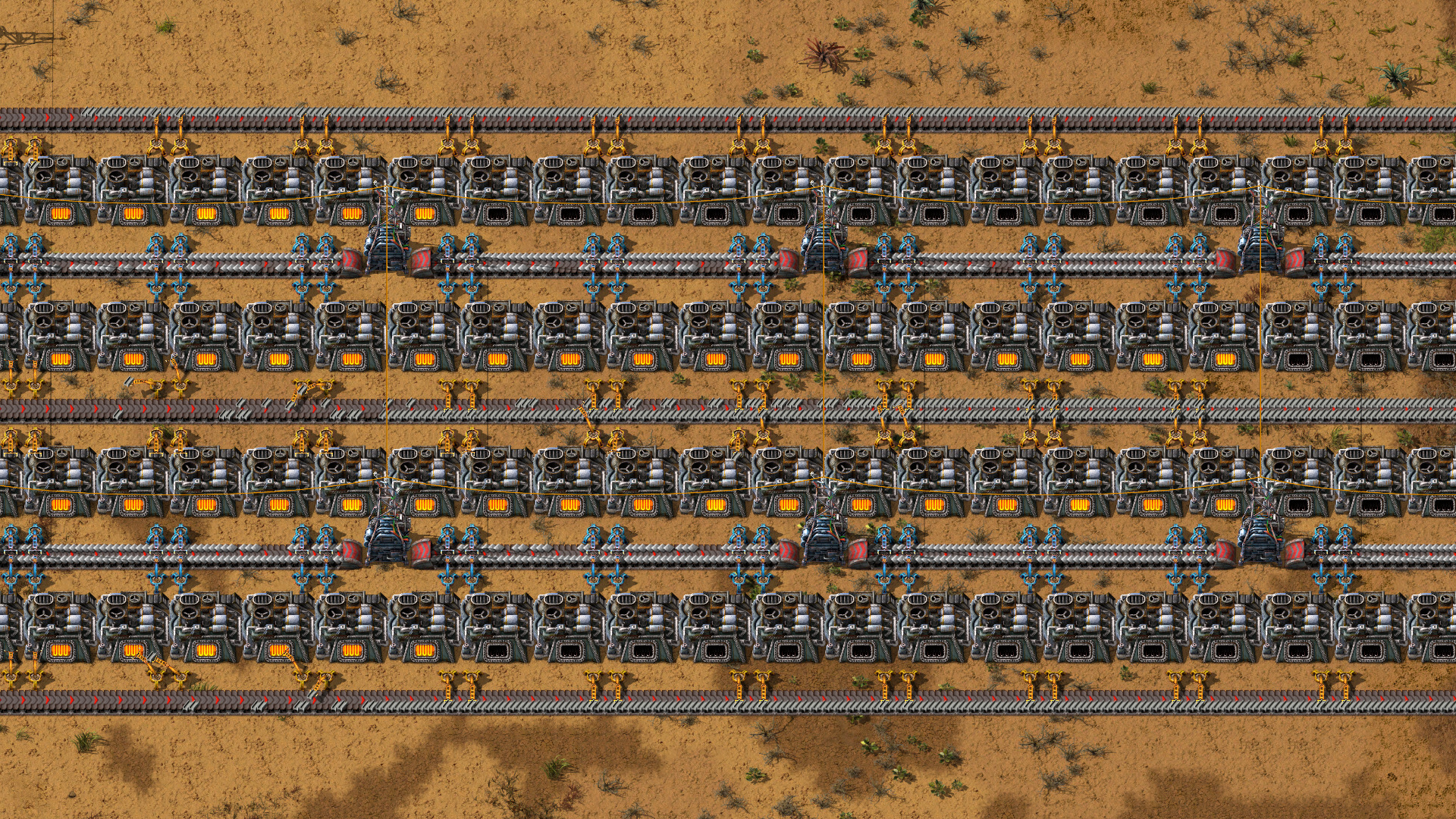 搬送ベルトと電気炉が列になって並ぶFactorio本体の工場