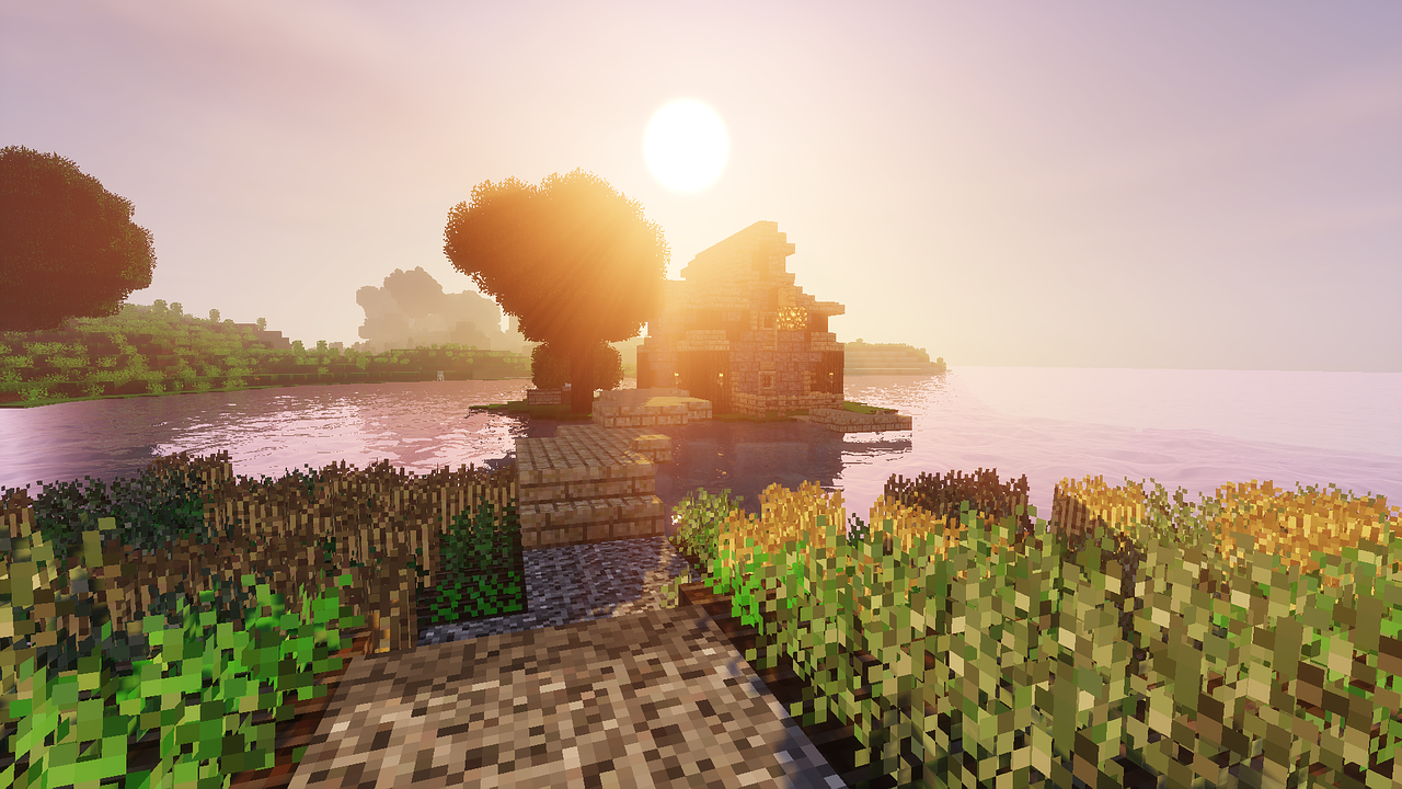 Minecraftの水辺に建てられた家と、手前に広がる小麦畑